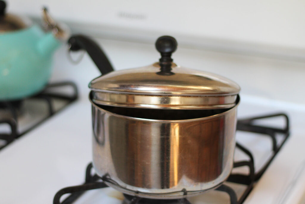 Peruvian Beans in a pot with water on stove. Cooking Peruano beans in water. Boiling Mayocoba beans in water on stovetop. 
