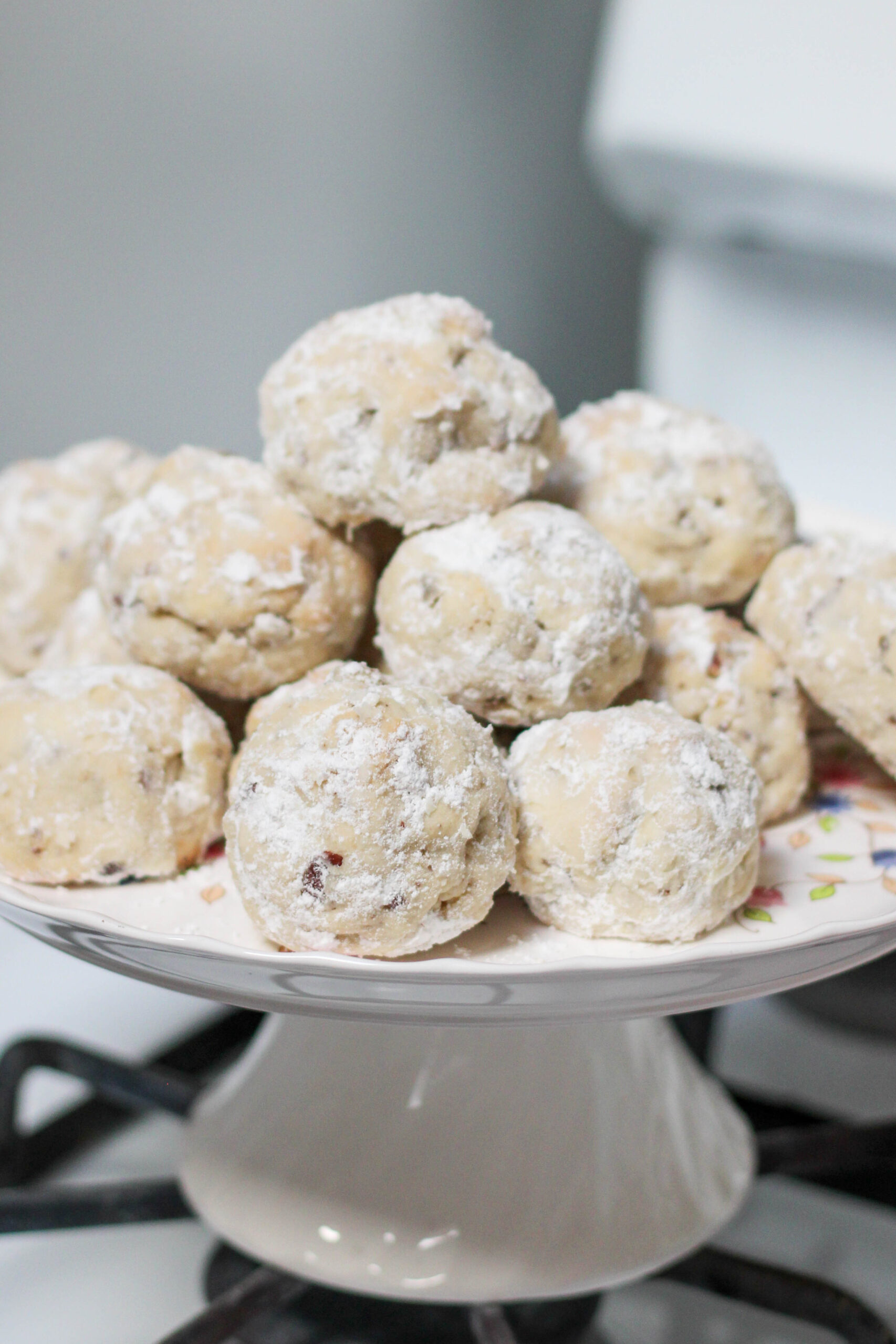 Besos de Nuez stacked on a white serving platter with white background.
