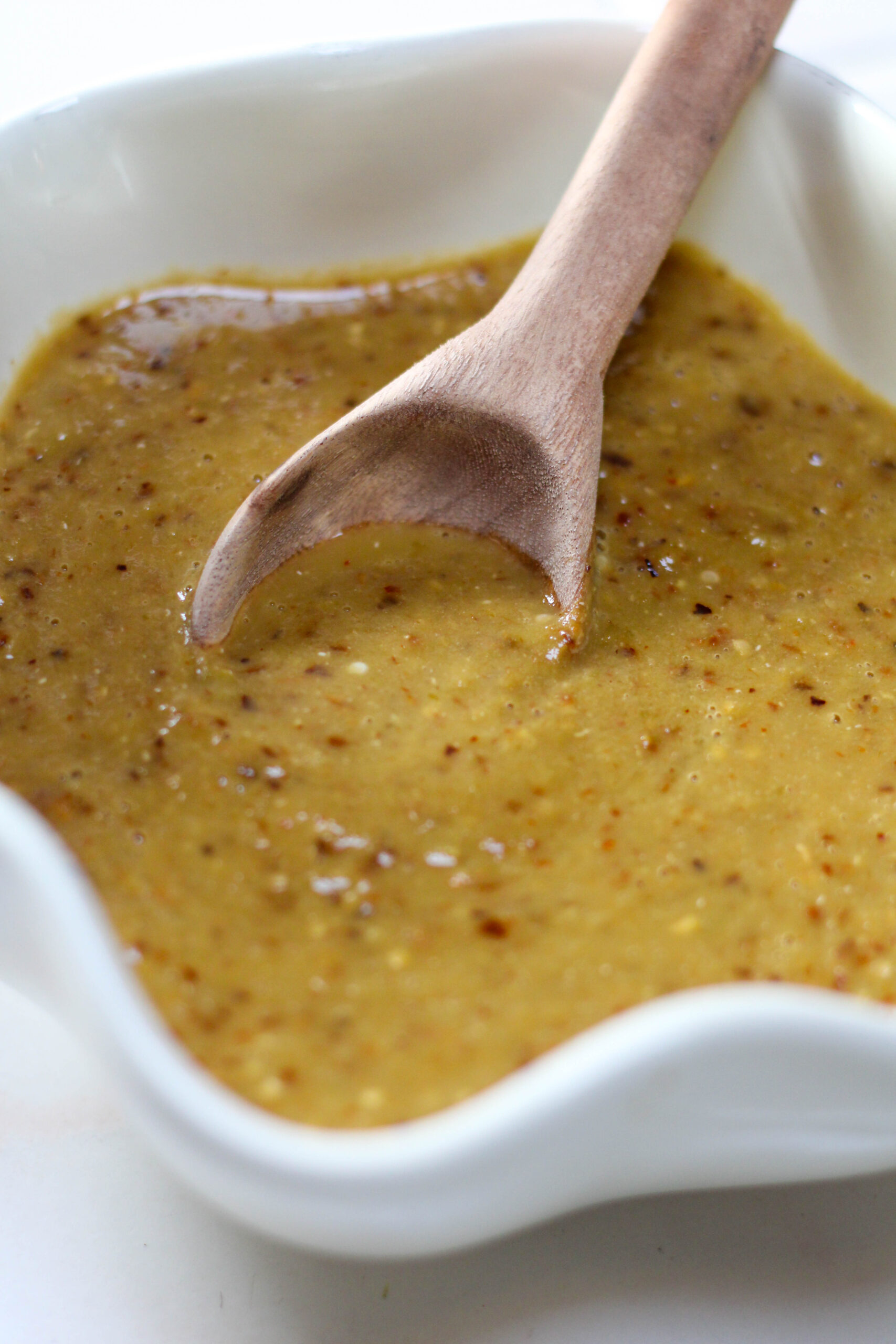 Salsa de chile árbol in a white bowl with wooden spoon. Easy and spicy salsa for tacos in a bowl with chile de árbol.