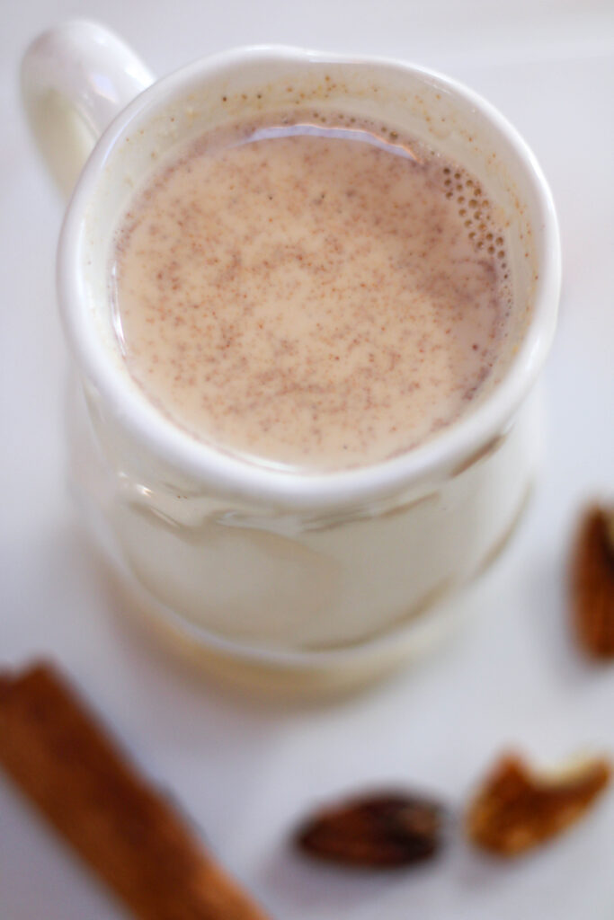 Atole de Nuez served in a white mug with a white background.