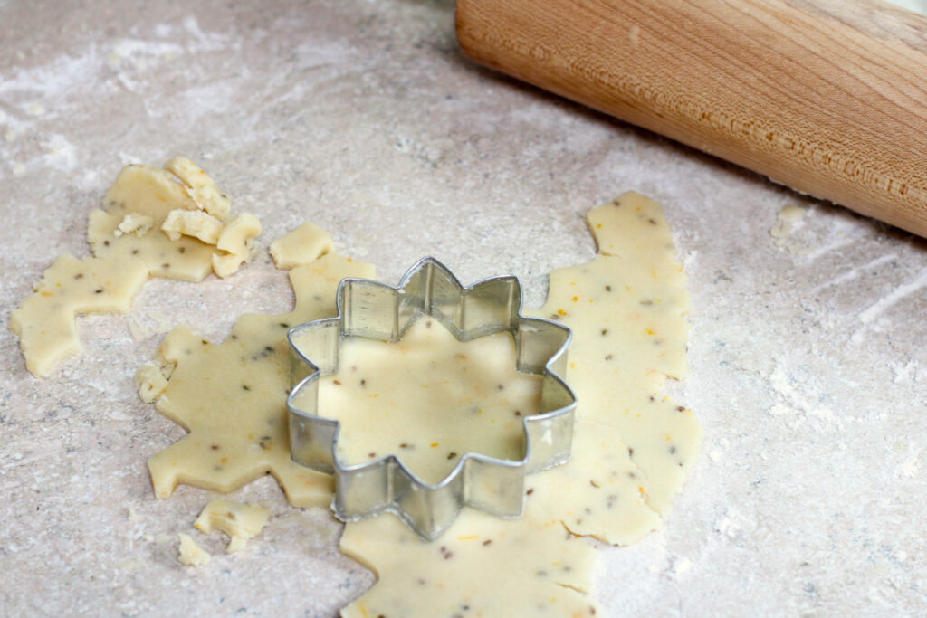 Using a cookies cutter to cut our bizcochito cookies.
