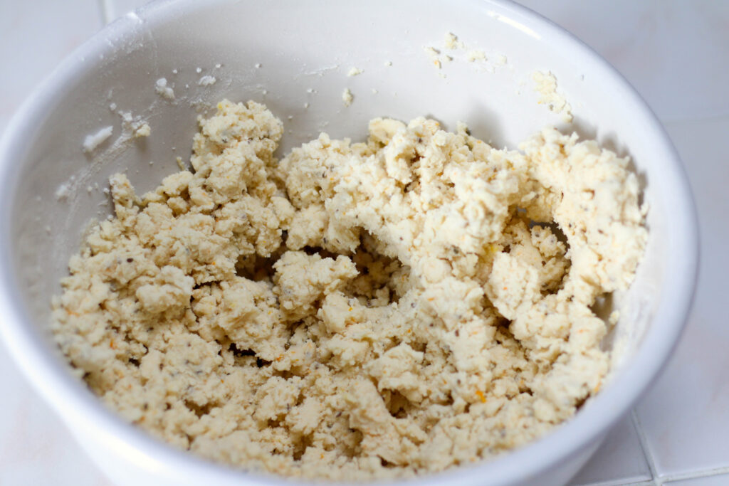 Dough for bizcochitos in a white bowl.