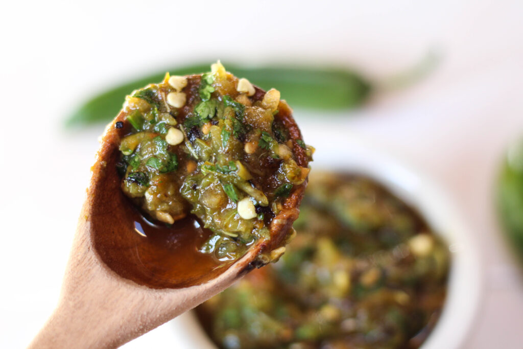 Roasted serrano salsa in a wooden spoon. 