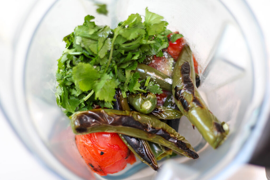 Serrano peppers, tomatoes, cilantro and salt in a blender. 