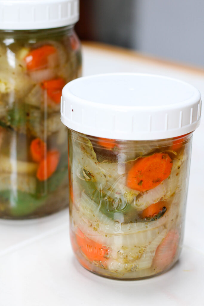 Jalapeños en escabeche in glass jars with white lid