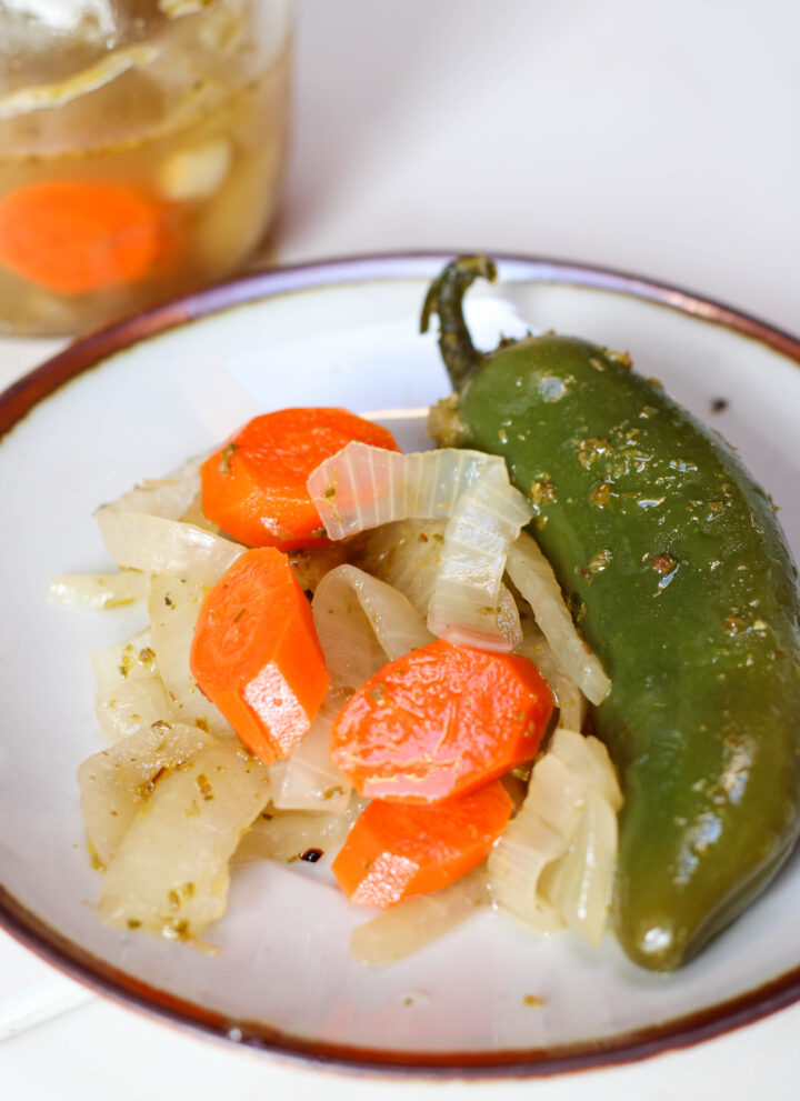 Jalepeños en escabeche on a white plate with white background