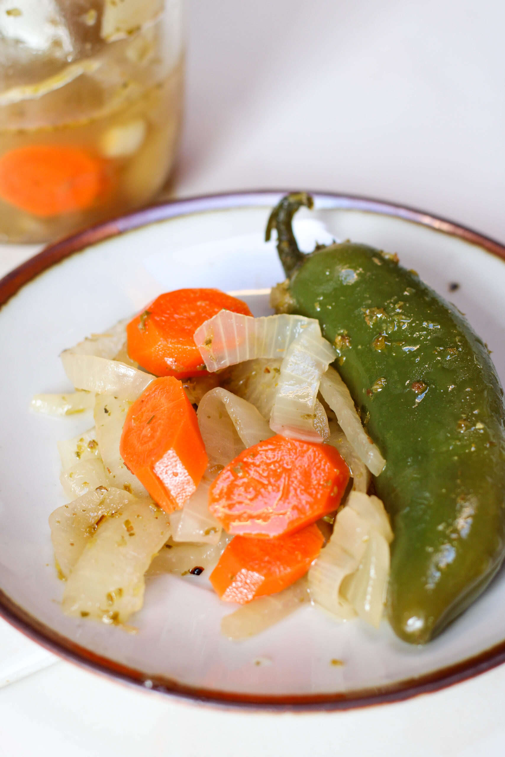 Jalepeños en escabeche on a white plate with white background