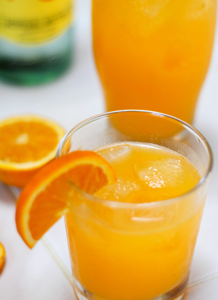 Glasses of naranjada mineral with a white background