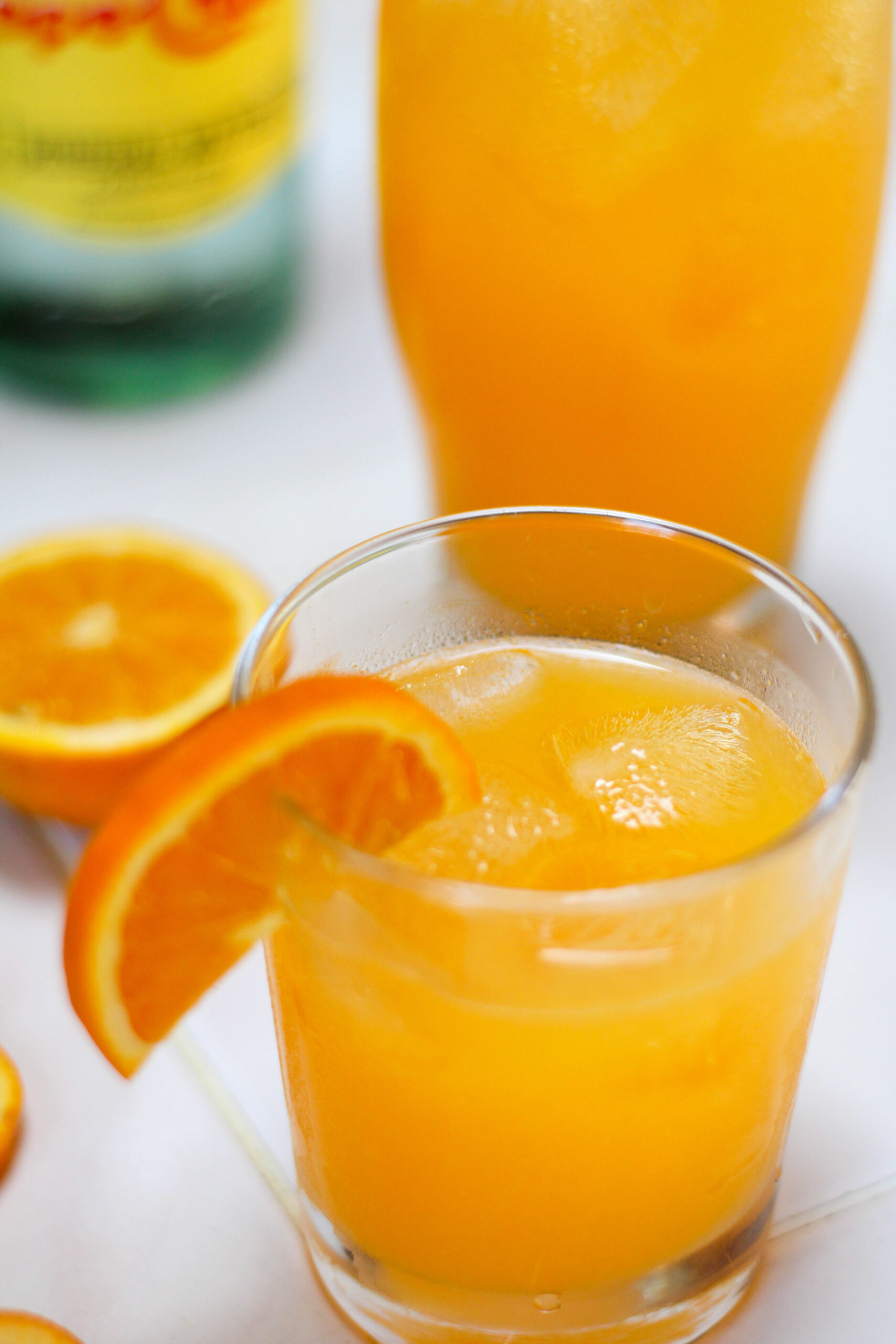 Glasses of naranjada mineral with a white background