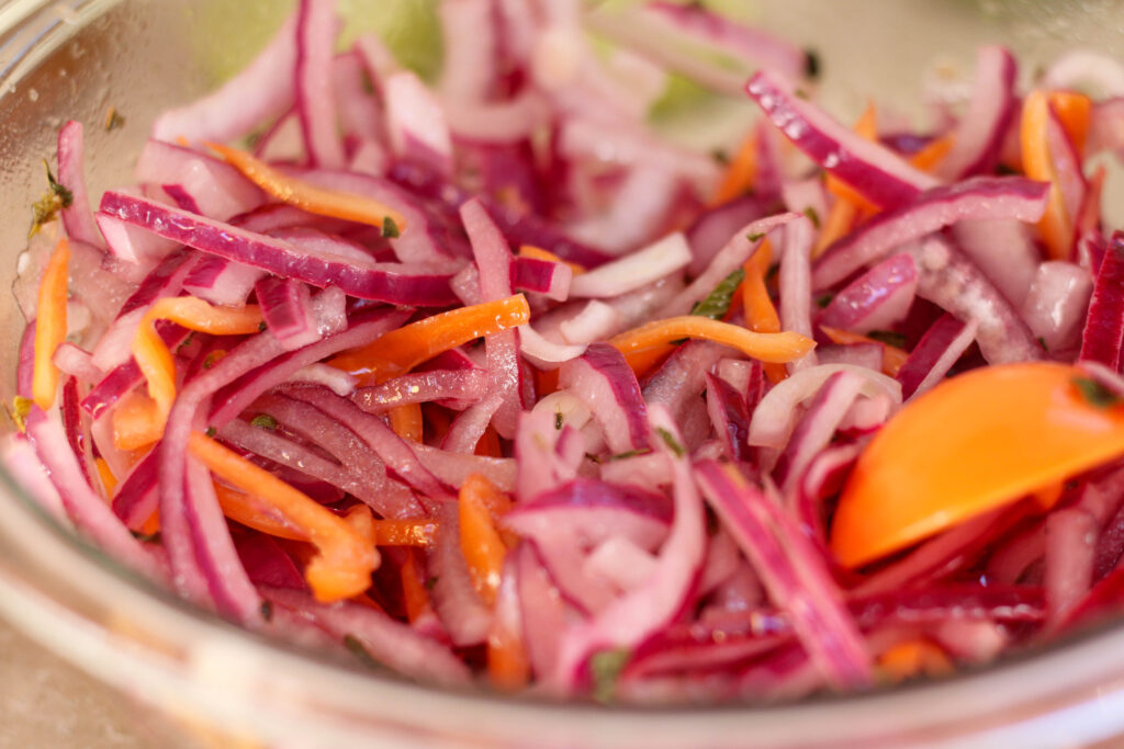close up photo of habanero con cebolla morada in a glass bowl