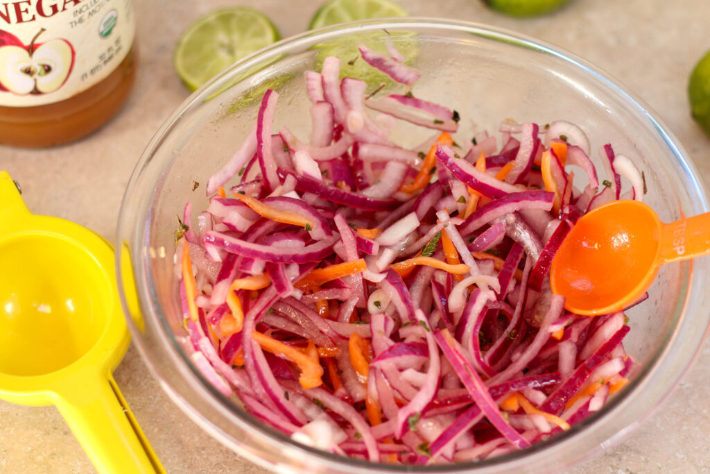 habanero con cebolla in a glass bowl with a colorful background