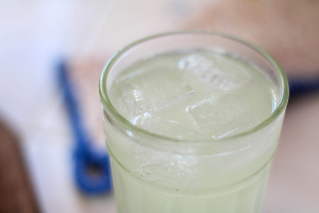Glass of homemade limonada soda with white background