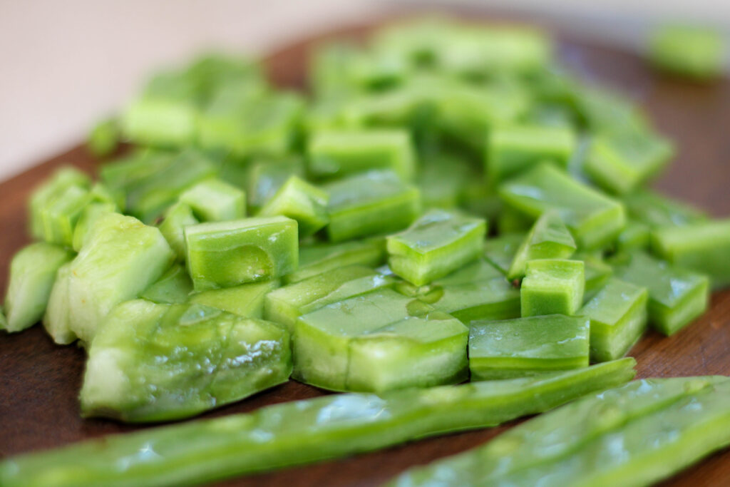 Chopped nopalitos or prickly pear cactus pads on wood cutting board