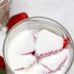 Fresas con crema in a short glass on a white table