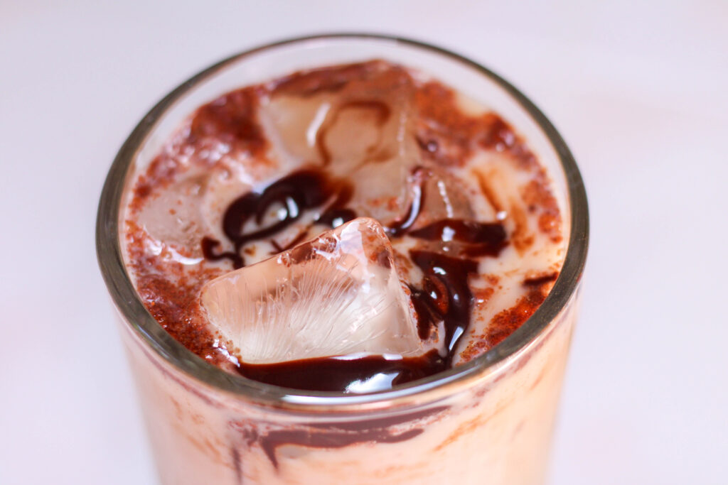 Iced mexican mocha in a glass with white background