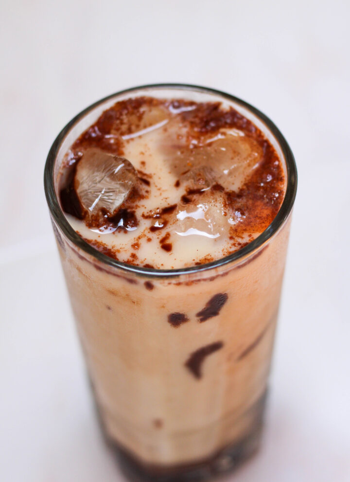 Iced Mexican mocha in a tall glass on a white table