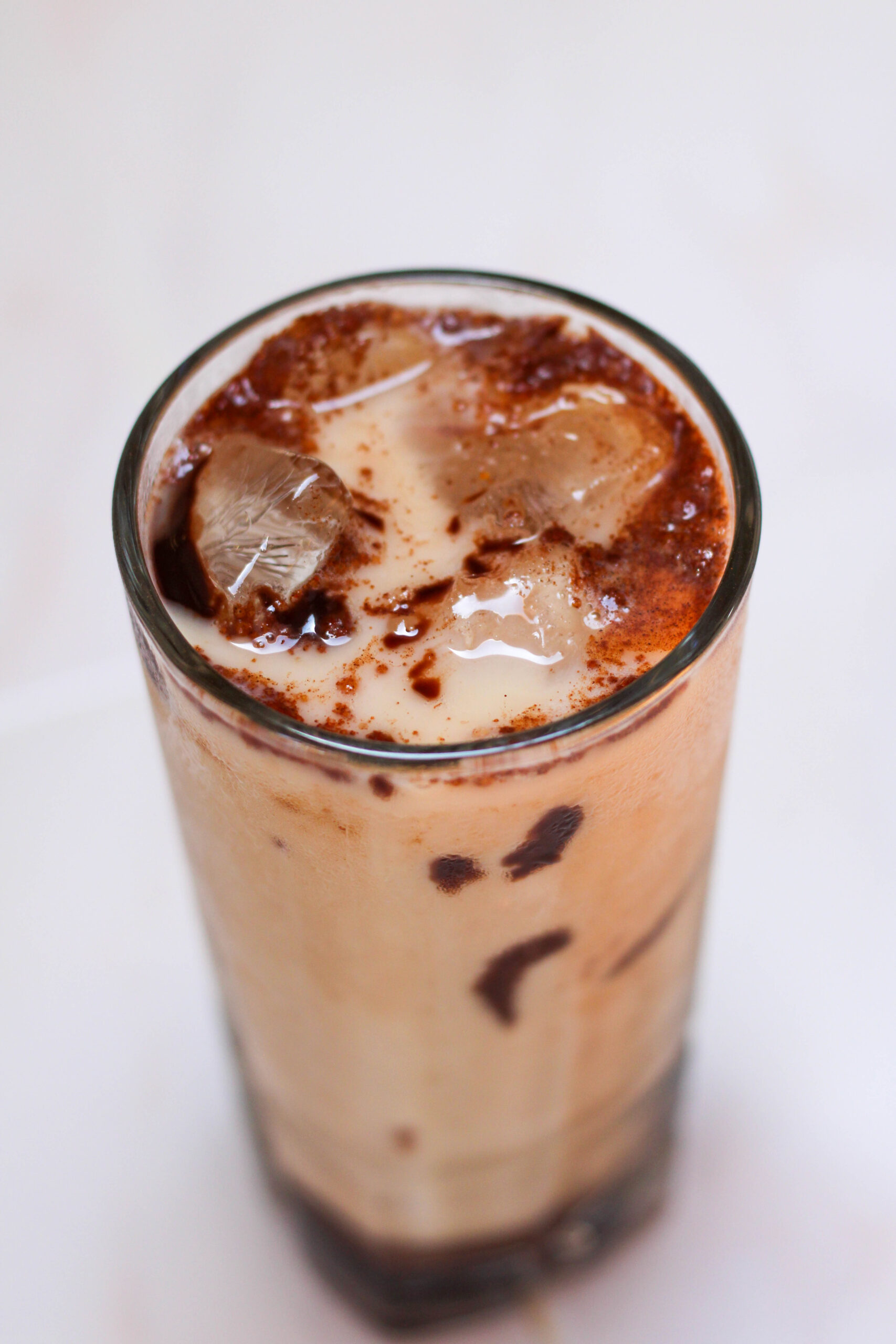 Iced Mexican mocha in a tall glass on a white table