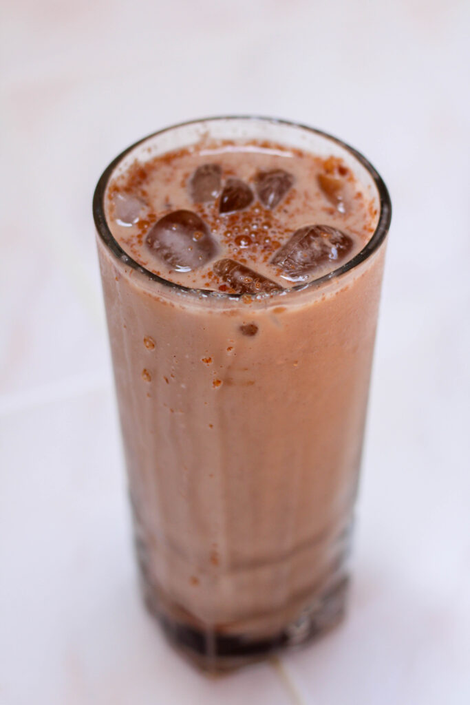 iced Mexican mocha in a tall glass on a white table