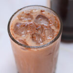iced Mexican mocha in a tall glass on a white table