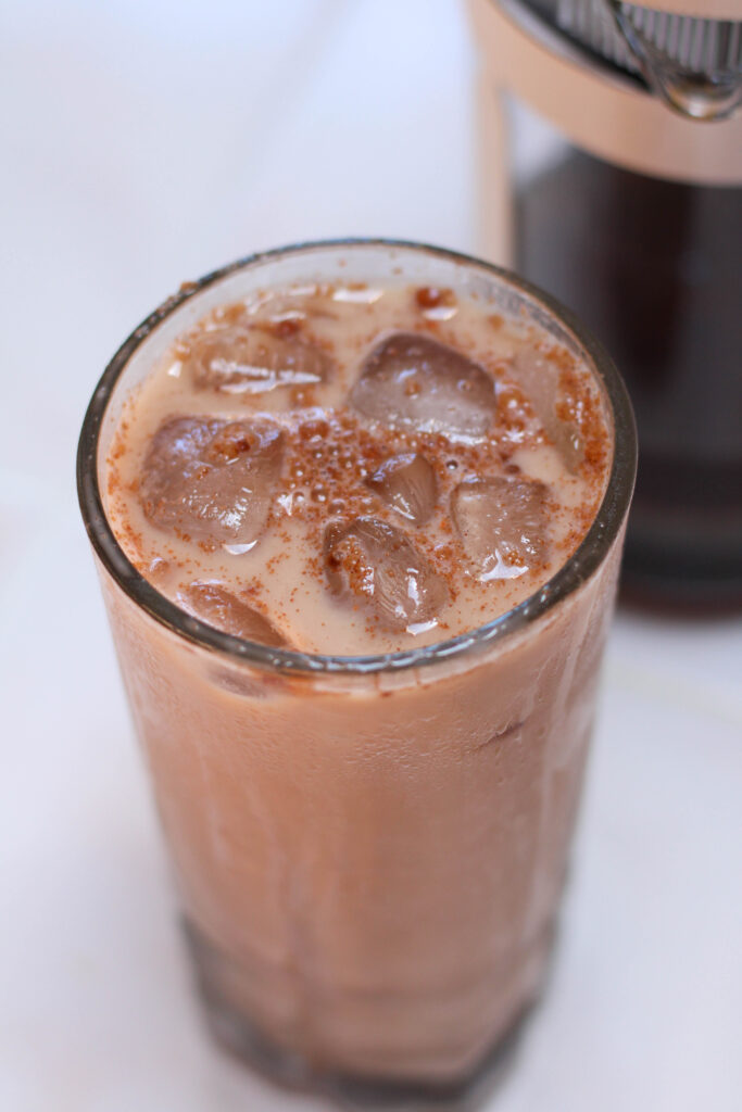 iced Mexican mocha in a tall glass on a white table
